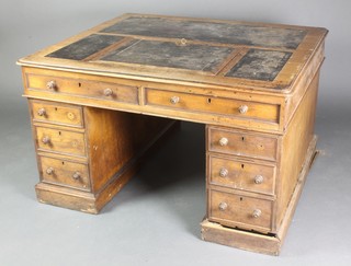 A Victorian light oak kneehole desk with leather writing surface to the top, the base fitted 2 long drawers above 6 short drawers 27 1/2"h x 47"w x 41 1/2"d 