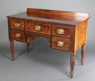 A William IV mahogany dressing table/sideboard with raised back, fitted 1 long drawer flanked by 2 short drawer, raised on turned and reeded supports 35"h x 48"w x 23"d