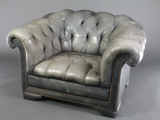 A Chesterfield style armchair upholstered in light blue buttoned back leather 