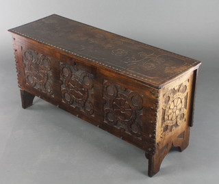 A 17th Century style rectangular carved oak coffer of panelled construction with hinged lid 17 1/2"h x 38"w x 13"d 