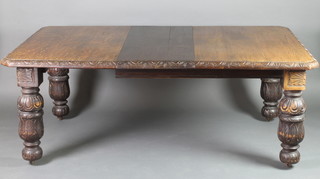 A Victorian oak extending dining table, raised on 4 cup and cover supports 
