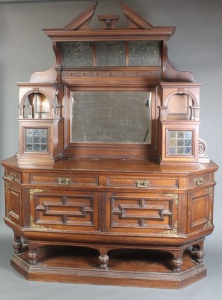 A late Victorian walnut chiffonier sideboard with raised mirrored back flanked by a pair of cupboards and niches of 2 short and 2 long drawer, the base fitted cupboards, raised on turned and block supports with platform base 95"h x 78"w 