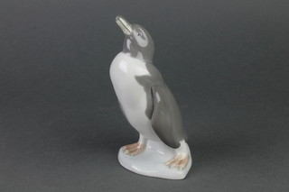 A Lladro figure of a standing penguin 7" 