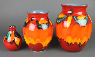 A contemporary Poole baluster vase with orange and red free form decoration 9 1/2", a ditto 8" and an oviform vase 5" 