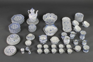 A Royal Copenhagen Onion pattern matched quantity of tableware comprising a coffee pot, 10 coffee cups, 6 tea cups, 1 other cup, 11 saucers, 3 jugs, 4 vases, a fruit bowl, oval dish, hors d'oeuvres dish, trefoil dish, 8 small plates, 6 medium plates, 11 small saucers, 6 medium saucers, a pair of condiments, a bowl, a bottle opener, 8 small dishes, 7 plates, a bowl and dish 