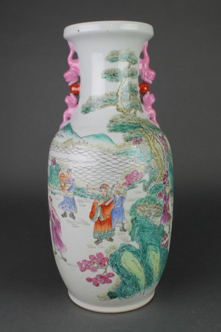 A famille rose oviform vase decorated with figures in an extensive country landscape with stylised dragon handles 17 3/4" 