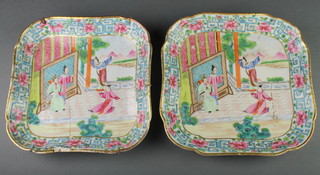 A pair of 19th Century famille rose shallow square dishes, decorated with figures before pavilions in a floral border 9" 