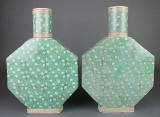 A pair of Chinese octagonal flattened vases with cylindrical necks, the green ground with flower heads 15" 