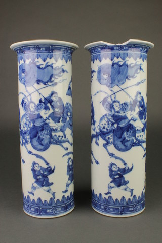A pair of Chinese blue and white cylindrical vases with battle scenes beneath floral lappets 13 1/2" 