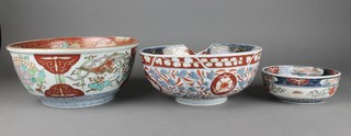 A 19th Century Imari deep bowl with a panel of a heron, surrounded by panels of garden landscapes 12", 2 others