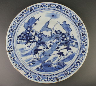 A late 19th Century Chinese blue and white charger, the formal floral border enclosing a battle scene 16" 
