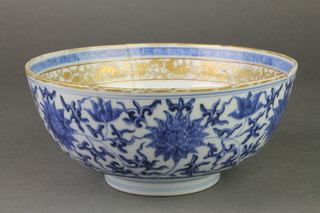 An early 19th Century Chinese blue and white deep bowl decorated with formal scrolling flowers, the interior with a band of gilt scrolling decoration and insects, 6 character mark to base 8"