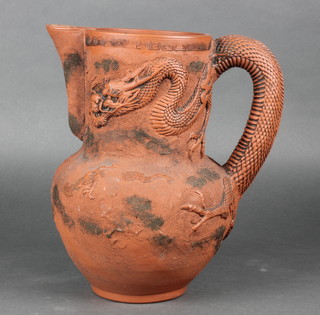 A Chinese earthenware jug decorated with a dragon chasing a flaming pearl 12" 