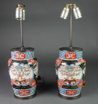 A pair of Japanese Imari oviform vases decorated with panels of vases of flowers 10" converted to electricity 