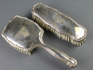 A silver plated hairbrush and clothes brush decorated German eagle 