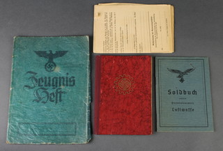 A Luftwaffe pay book? marked Soldbuch together with various passes etc 