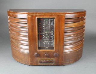 A GEC B.C. 4750 radio contained in a crescent shaped mahogany case 