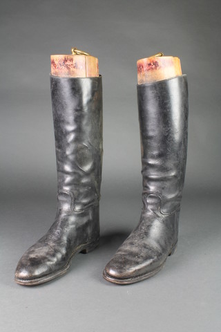 A pair of black leather riding boots complete with trees 