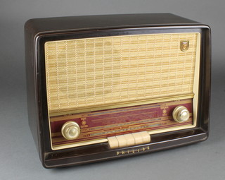 A Philips radio contained in a brown and white bakelite case 