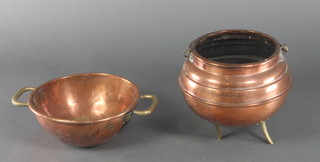 A circular copper and brass cauldron, with old repair to base together with a circular copper twin handled dish with brass handles 12" 