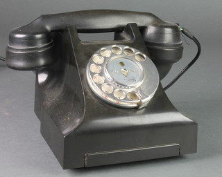 A black Bakelite dial telephone, the base marked 832L FWR 61/2 E11