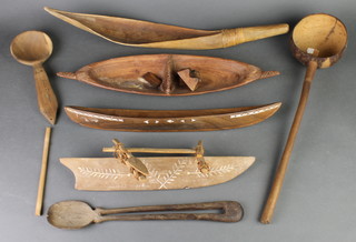4 Eastern models of canoes, a carved wooden spoon and 2 scoops