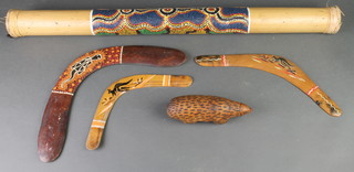 An Australian rain stick, 3 carved and painted wooden boomerangs, a carved wooden figure of an animal 7" 