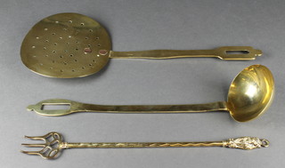 A 19th Century brass cream skimmer, a brass ladle and toasting fork 
