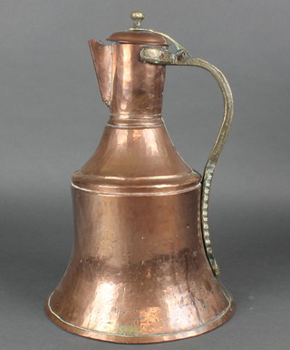 An Eastern copper bell shaped jug with brass handle 16"  