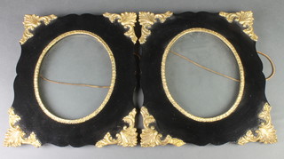 A pair of rectangular gilt metal and black frames with oval apertures 14" x 12 1/2" 