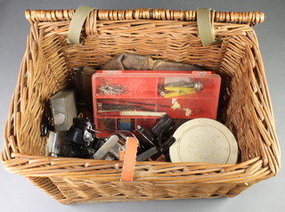 A fishing basket seat with contents comprising reel tackle including a Mitchell 410, an Abu closed face fishing reel and other items 