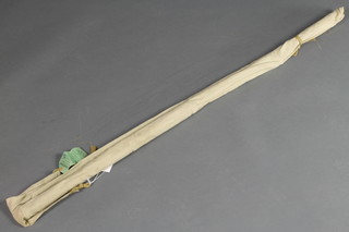 A Milbor 8' spinning rod with original cloth sleeve and label 