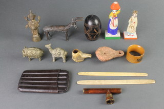 An Eastern bronze figure of a standing Deity 4", a bronze figure of an "antelope" 3", a stag horn pipe and other curios 