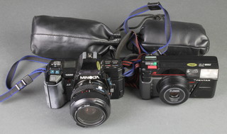 A Minolta 7000 camera with Minolta zoom lens marked 35-70mm 1:4 (22), a Pentax zoom 70 camera, a Sigma UC zoom lens 7-50mm 1:4-56, a Minolta AF zoom 100-200mm 1:4.5 (22) lens