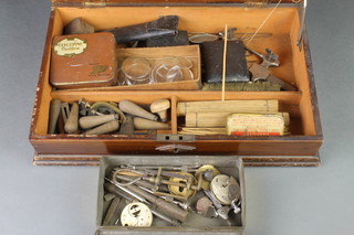 A collection of various watchmakers equipment contained in a metal tin and a wooden box 