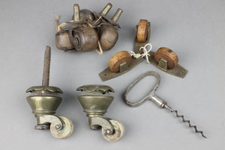A 19th Century polished steel corkscrew, 4 19th Century wooden casters, 2 19th Century brass casters and 3 other casters 