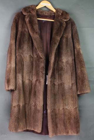 A lady's brown tinted half length fur coat