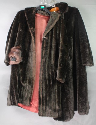 Dyna Mink, a lady's black simulated fur full length coat together with a ditto stole, 1 other black full length coat by H F Greenfield 
