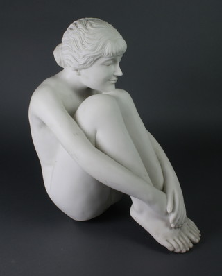 A white resin figure of a seated girl 18"