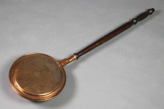 A copper warming pan, the lid engraved a bird with turned mahogany handle 