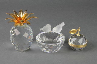 A Swarovski ashtray with 2 doves 3", a ditto apple paperweight and a ditto pineapple paperweight 4" 