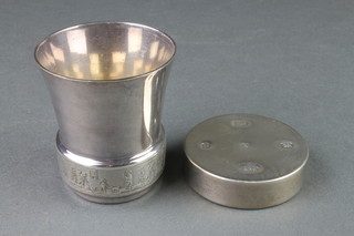 A contemporary silver weighted paperweight and a repousse tot