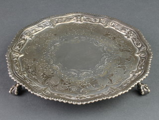 A George III silver card tray with chased floral and fruit decoration and gadrooned border on claw and ball feet, London 1768, 146 grams
