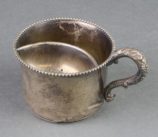A Sterling silver moustache cup with beaded decoration and S scroll handle 102 grams A plated spoon.