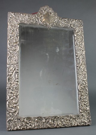 An Edwardian repousse silver easel photograph frame with scroll decoration and vacant cartouche, Birmingham 1904 20" x 14"  