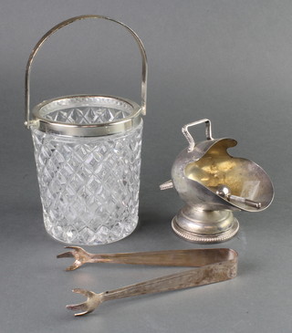 A silver plated mounted glass ice bucket, tongs and a sugar scuttle 
