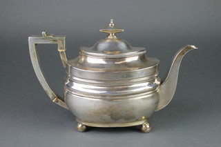 A George III rounded rectangular teapot with urn finial and simple handle on ball feet, London 1808, 664 grams