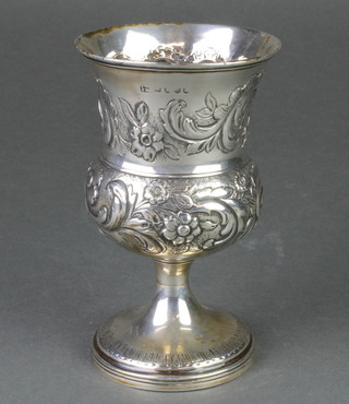 A George III repousse silver waisted goblet with scroll decoration and vacant cartouches, 202 grams