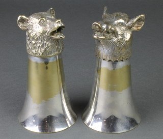 A pair of modern silver plated stirrup cups in the form of a boar and bear 