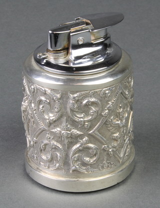 An Indian repousse white metal cigarette lighter 